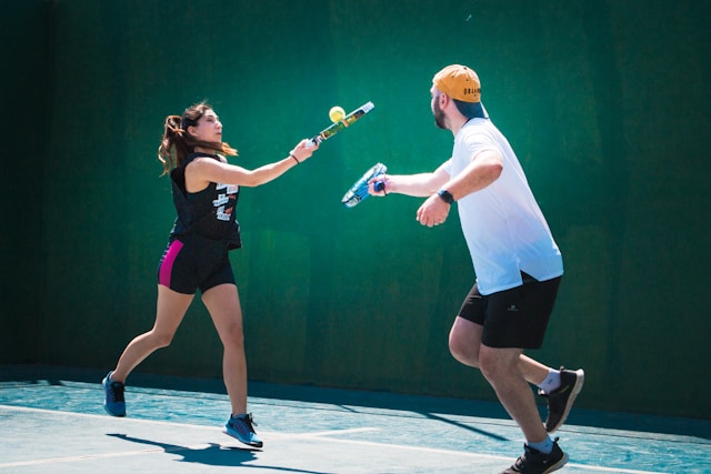 man and woman playing racquetball