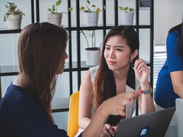 woman listening to another woman